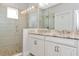 Bathroom with a double sink vanity featuring granite countertop and large walk-in shower at 5561 Cannes Cir # 5101, Sarasota, FL 34231