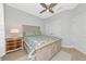 Comfortable bedroom with a queen bed, wood-look flooring, and a ceiling fan at 5561 Cannes Cir # 5101, Sarasota, FL 34231