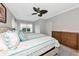 Well-lit bedroom featuring stylish furniture and a ceiling fan at 5561 Cannes Cir # 5101, Sarasota, FL 34231