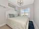 Bright bedroom with beach-themed wall art and a comfy white bed at 5561 Cannes Cir # 5101, Sarasota, FL 34231