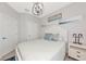 Cozy bedroom with beach-themed decor and a white cottage-style bed frame at 5561 Cannes Cir # 5101, Sarasota, FL 34231