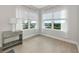 Bright bedroom features two windows with sheer curtains and wood-look tile flooring at 5561 Cannes Cir # 5101, Sarasota, FL 34231