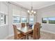 Dining room with natural light. Features wooden table and chairs at 5561 Cannes Cir # 5101, Sarasota, FL 34231