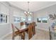 Bright dining room featuring a wooden table and chairs, complemented by natural light at 5561 Cannes Cir # 5101, Sarasota, FL 34231