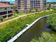 Aerial view of community dock and lush tropical landscaping at 5561 Cannes Cir # 5101, Sarasota, FL 34231
