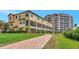 Exterior building view with well-maintained walkway and tropical landscaping at 5561 Cannes Cir # 5101, Sarasota, FL 34231