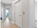 Hallway featuring neutral walls, modern lighting, wood-look flooring, and classic white doors at 5561 Cannes Cir # 5101, Sarasota, FL 34231
