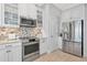Charming kitchen with stainless steel appliances, bright white cabinets, and a stylish tile backsplash at 5561 Cannes Cir # 5101, Sarasota, FL 34231
