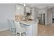 Bright, modern kitchen features stainless steel appliances, a tile backsplash, and bar stool seating at 5561 Cannes Cir # 5101, Sarasota, FL 34231