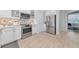 Well-lit kitchen featuring stainless steel appliances and white cabinets with modern backsplash at 5561 Cannes Cir # 5101, Sarasota, FL 34231