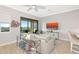 Living room with a modern sofa, balcony, and a television, creating an inviting atmosphere at 5561 Cannes Cir # 5101, Sarasota, FL 34231