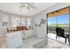 Comfortable living area with a large gray sofa, and balcony access at 5561 Cannes Cir # 5101, Sarasota, FL 34231