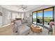 Inviting living space with a comfortable sofa, dining area, and a sliding door leading to a balcony at 5561 Cannes Cir # 5101, Sarasota, FL 34231
