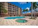 Beautiful community pool and spa with pergolas, seating areas, and lush landscaping for a relaxing experience at 5561 Cannes Cir # 5101, Sarasota, FL 34231