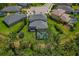 Aerial view of a home with a screened pool, trampoline, spacious backyard, and neighboring properties at 5805 49Th E Ct, Ellenton, FL 34222