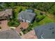 Aerial view of a home with a screened pool, trampoline, and lush landscaping at 5805 49Th E Ct, Ellenton, FL 34222