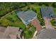 Aerial view of a property with a screened-in pool, surrounded by a lush lawn at 5805 49Th E Ct, Ellenton, FL 34222