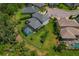 Aerial view of a home with a screened pool, trampoline, spacious backyard, and well-maintained landscaping at 5805 49Th E Ct, Ellenton, FL 34222