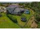 Aerial view showcasing backyard with screened pool, trampoline and manicured landscaping at 5805 49Th E Ct, Ellenton, FL 34222