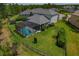 Aerial view of backyard featuring a screened pool, trampoline, and privacy fence at 5805 49Th E Ct, Ellenton, FL 34222