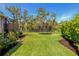 Well-maintained lawn, surrounded by lush landscaping, offering ample space for recreational activities and gardening at 5805 49Th E Ct, Ellenton, FL 34222