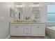 Spacious bathroom with dual sinks, granite countertops, modern fixtures, and ample storage space at 5805 49Th E Ct, Ellenton, FL 34222