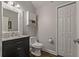 Updated half bathroom with decorative mirror, marble countertop, and a convenient closet at 5805 49Th E Ct, Ellenton, FL 34222