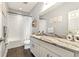 Well-lit bathroom with granite countertop, white cabinets, and shower featuring a shower curtain at 5805 49Th E Ct, Ellenton, FL 34222