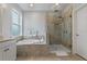 Luxurious bathroom with a soaking tub, tiled shower, and designer fixtures, for a spa-like experience at 5805 49Th E Ct, Ellenton, FL 34222