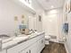Bright bathroom featuring white cabinets, granite countertops, and shower-tub combo at 5805 49Th E Ct, Ellenton, FL 34222