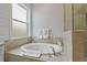 Close up of relaxing soaking tub with tile surround and shower in luxurious bathroom at 5805 49Th E Ct, Ellenton, FL 34222