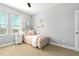 Bedroom featuring neutral tones, a cozy bed, and ample natural light from the window at 5805 49Th E Ct, Ellenton, FL 34222