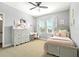 A charming bedroom with a neutral color palette, dresser, decor, and natural light from the windows at 5805 49Th E Ct, Ellenton, FL 34222