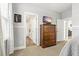 Bedroom leading to bathroom with wood floor and a dresser with wall mounted tv at 5805 49Th E Ct, Ellenton, FL 34222