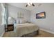 Bright bedroom featuring neutral color palette, artwork, and a mounted TV at 5805 49Th E Ct, Ellenton, FL 34222