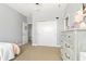 Bedroom with dresser, closet, and neutral color scheme, creating a cozy and inviting space at 5805 49Th E Ct, Ellenton, FL 34222