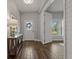 Elegant foyer featuring wood-look tile flooring, stylish console table, and a view of the front door at 5805 49Th E Ct, Ellenton, FL 34222