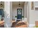 Inviting front entrance with a dark blue door, potted plants, overhead lighting, and textured columns at 5805 49Th E Ct, Ellenton, FL 34222