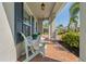 Inviting front porch with comfortable seating, brick flooring, and charming curb appeal at 5805 49Th E Ct, Ellenton, FL 34222