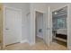 Bright hallway leading to the main bedroom and bath featuring neutral colors and tile flooring at 5805 49Th E Ct, Ellenton, FL 34222