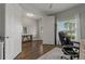 Cozy home office view showcasing tile floors, an ergonomic chair, and natural light through the windows at 5805 49Th E Ct, Ellenton, FL 34222