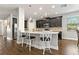 Beautiful kitchen island with granite counters, stylish chairs and pendant lights above at 5805 49Th E Ct, Ellenton, FL 34222