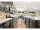Open-concept kitchen featuring dark wood cabinets, an island, and stainless steel appliances at 5805 49Th E Ct, Ellenton, FL 34222