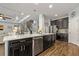 Gorgeous kitchen featuring an island with stainless dishwasher, granite countertops, and wood-look floors at 5805 49Th E Ct, Ellenton, FL 34222