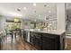 Open kitchen featuring granite countertops, stainless dishwasher, and wood-look tile flooring at 5805 49Th E Ct, Ellenton, FL 34222
