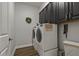 Modern laundry room featuring front load washer and dryer and built-in cabinets at 5805 49Th E Ct, Ellenton, FL 34222