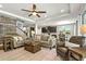Spacious living room features wood-look tile, and an open view of the kitchen and dining area at 5805 49Th E Ct, Ellenton, FL 34222