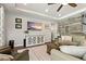 Open-concept living room with hardwood floors, tray ceiling, wood accent wall, and ample natural light at 5805 49Th E Ct, Ellenton, FL 34222