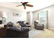 A living room featuring plush seating, a ceiling fan, a decorative rug, and natural light creating a cozy atmosphere at 5805 49Th E Ct, Ellenton, FL 34222