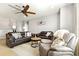 Spacious living area featuring leather couches, ceiling fan, decorative rug, and neutral color scheme, creating a relaxing ambiance at 5805 49Th E Ct, Ellenton, FL 34222
